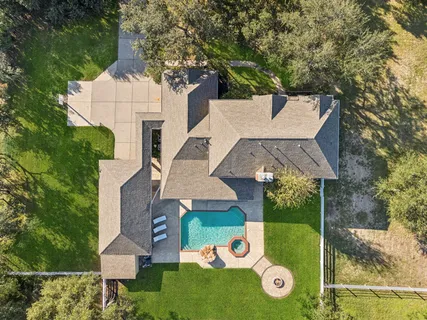 a view of a hallway with wooden floor and windows