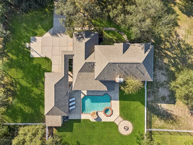 a view of a hallway with wooden floor and windows