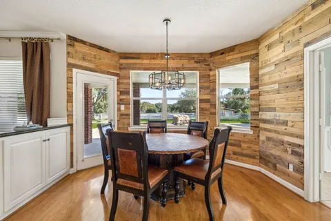 a dining room with furniture window wooden floor