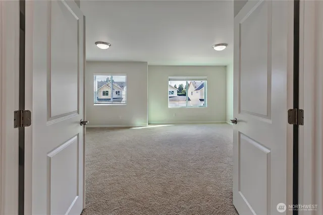 an empty room with windows and closet