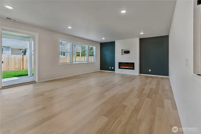 an empty room with windows and closet