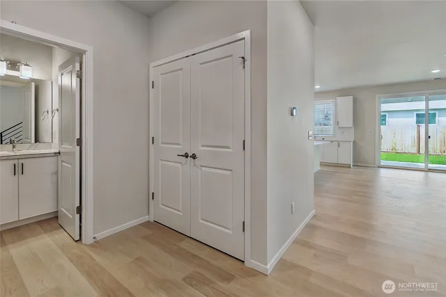 a view of a hallway with wooden floor