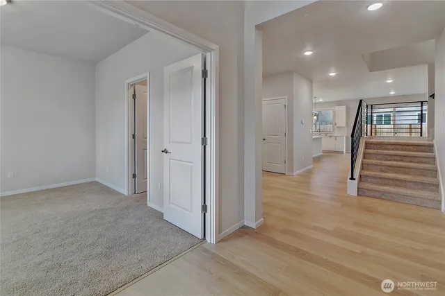a view of hallway with wooden floor
