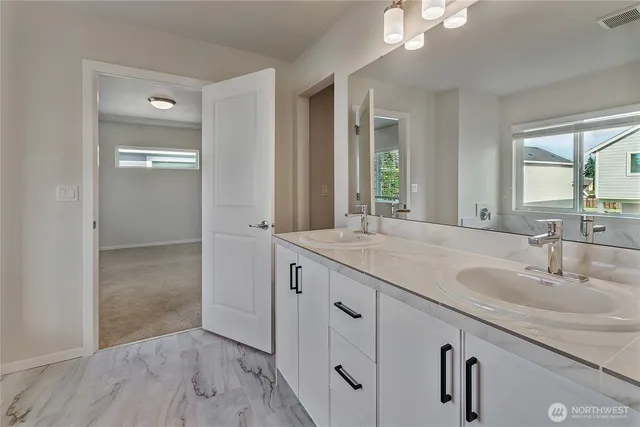 a bathroom with a sink double vanity and a mirror