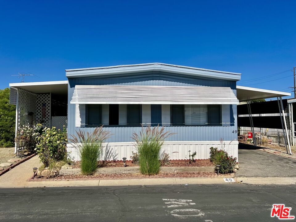 2744 West Rialto Avenue, Unit 49 Rialto, CA 92376 - Photo 1 of 40 a front view of a house with potted plants