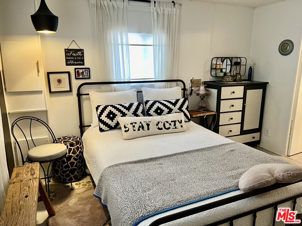 2744 West Rialto Avenue, Unit 49 Rialto, CA 92376 - Photo 14 of 40 a bedroom with a bed and furniture