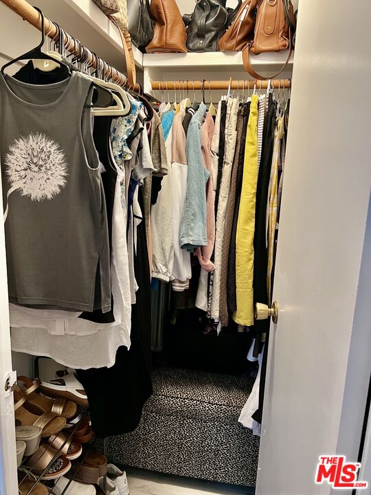 2744 West Rialto Avenue, Unit 49 Rialto, CA 92376 - Photo 15 of 40 a view of walk in closet with clothes and shoes