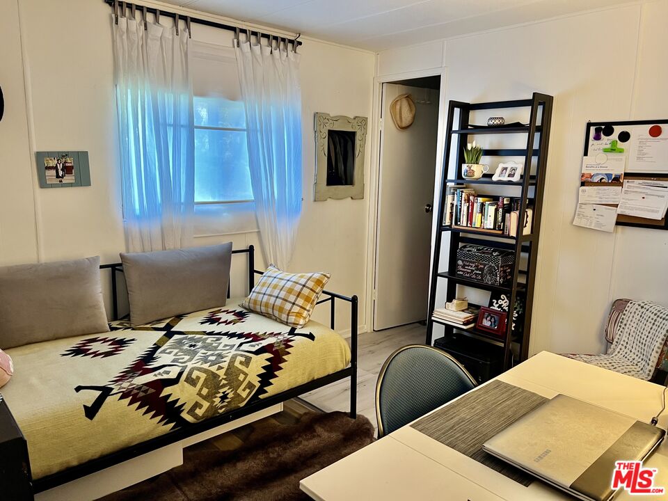 2744 West Rialto Avenue, Unit 49 Rialto, CA 92376 - Photo 20 of 40 a bedroom with furniture and a book shelf