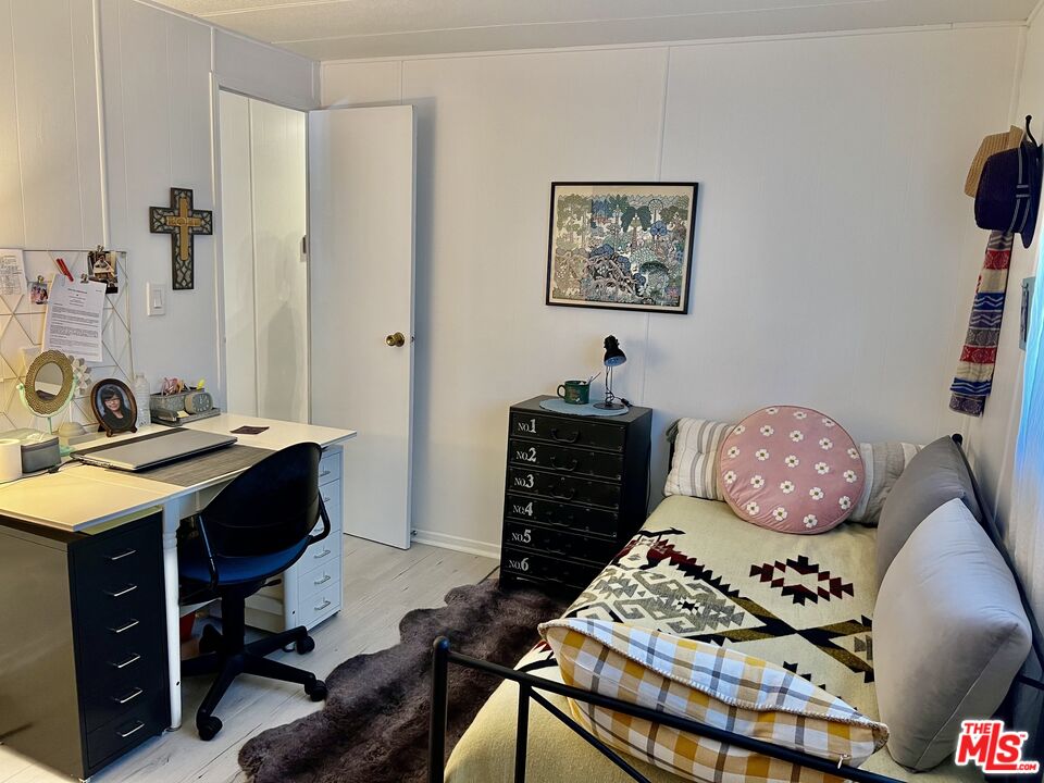 2744 West Rialto Avenue, Unit 49 Rialto, CA 92376 - Photo 21 of 40 a bedroom with a bed and a chandelier