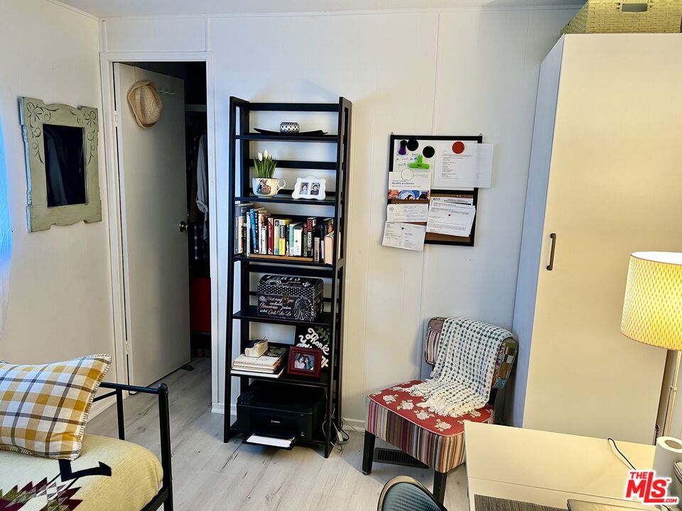 2744 West Rialto Avenue, Unit 49 Rialto, CA 92376 - Photo 23 of 40 a living room with furniture and book shelf