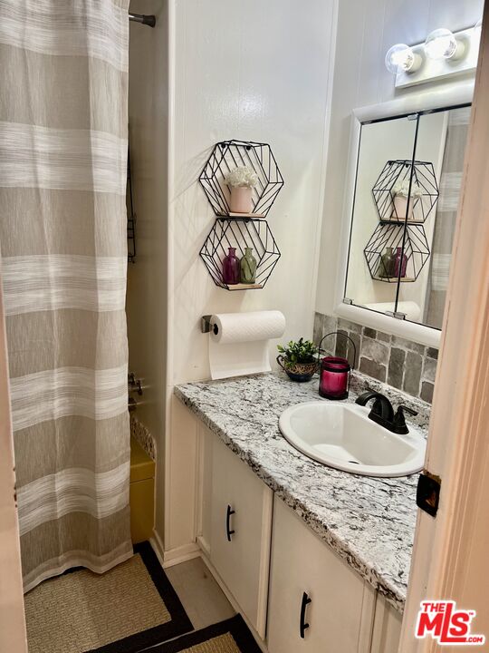 2744 West Rialto Avenue, Unit 49 Rialto, CA 92376 - Photo 24 of 40 a bathroom with a sink and a mirror