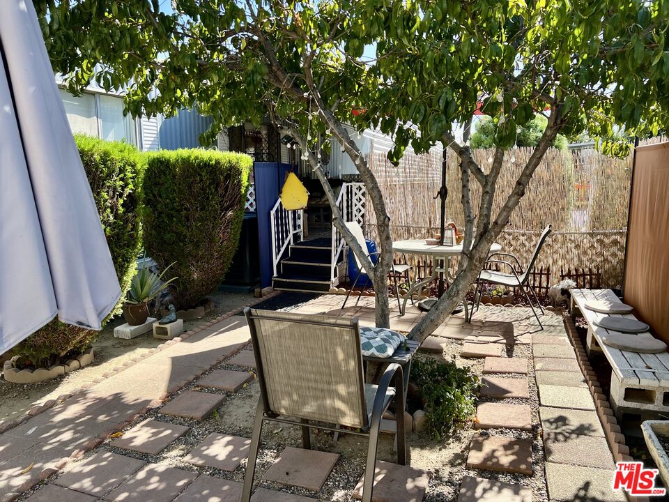 2744 West Rialto Avenue, Unit 49 Rialto, CA 92376 - Photo 33 of 40 a view of a chairs and table in backyard