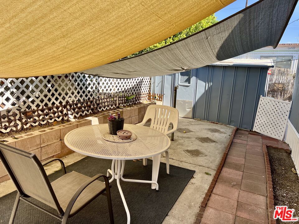 2744 West Rialto Avenue, Unit 49 Rialto, CA 92376 - Photo 34 of 40 a table and chairs sitting on a patio