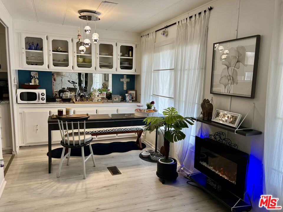 2744 West Rialto Avenue, Unit 49 Rialto, CA 92376 - Photo 7 of 40 a living room with furniture a fireplace and decor