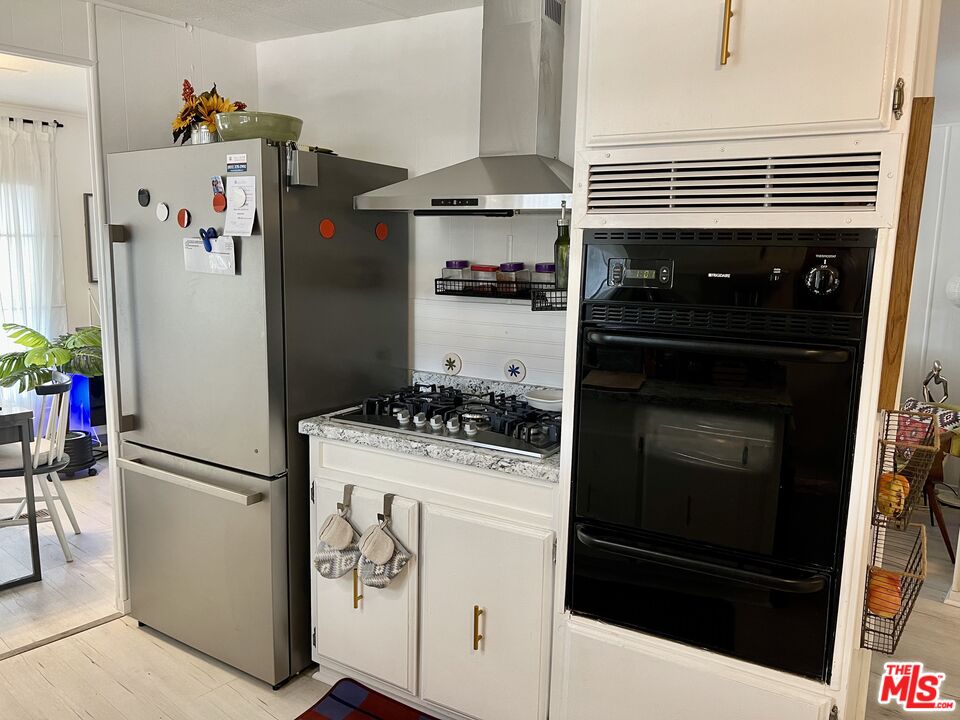 2744 West Rialto Avenue, Unit 49 Rialto, CA 92376 - Photo 9 of 40 a kitchen with appliances and cabinets
