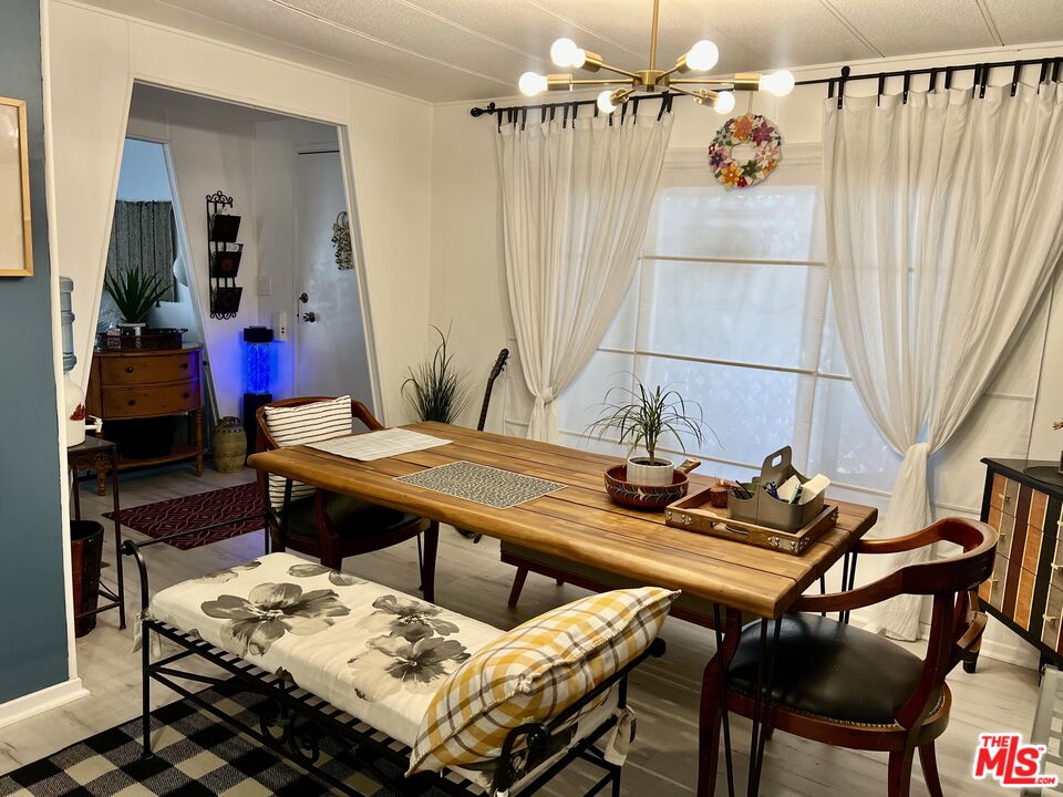 2744 West Rialto Avenue, Unit 49 Rialto, CA 92376 - Photo 10 of 40 a living room with a table and chairs