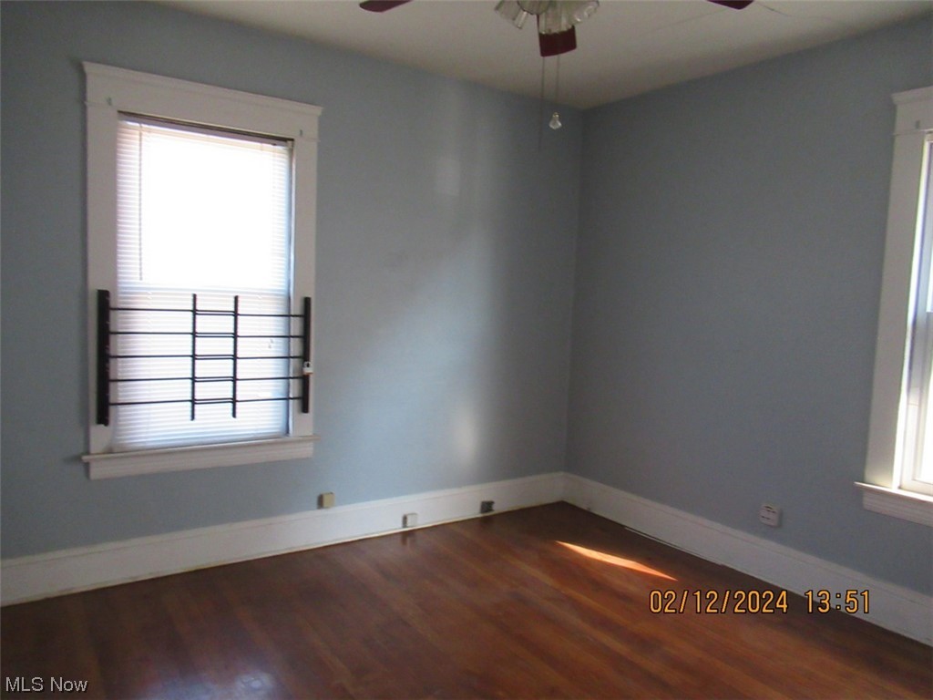1863 Noble Road Cleveland, OH 44112 - Photo 14 of 16 Empty room featuring plenty of natural light, ceiling fan, and dark wood-type flooring