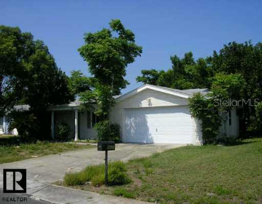 8825 Cochise Lane Port Richey, FL 34668 - Photo 1 of 1 front view of house with a yard