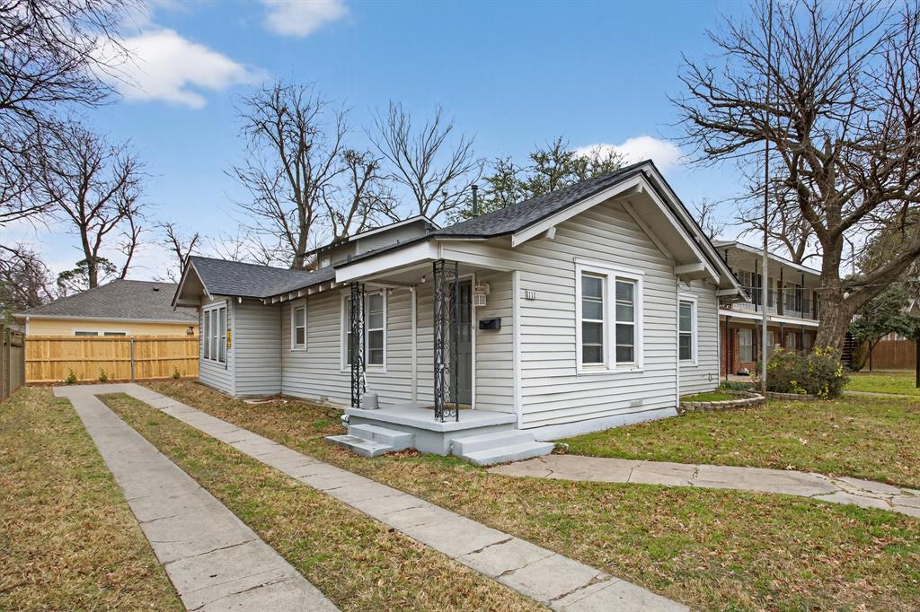 1111 North Austin Street Denton, TX 76201 - Photo 2 of 28 a front view of a house with a yard
