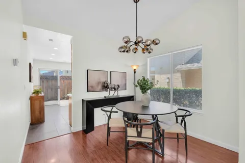a view of a dining room with furniture wooden floor and a chandelier