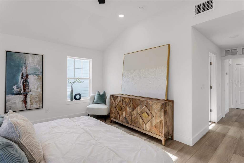 1912 West Chestnut Street Tampa, FL 33607 - Photo 21 of 30 a spacious bedroom with a bed and a painting on the wall