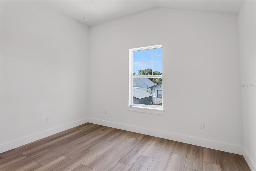 1912 West Chestnut Street Tampa, FL 33607 - Photo 26 of 30 a view of an empty room with wooden floor and a window