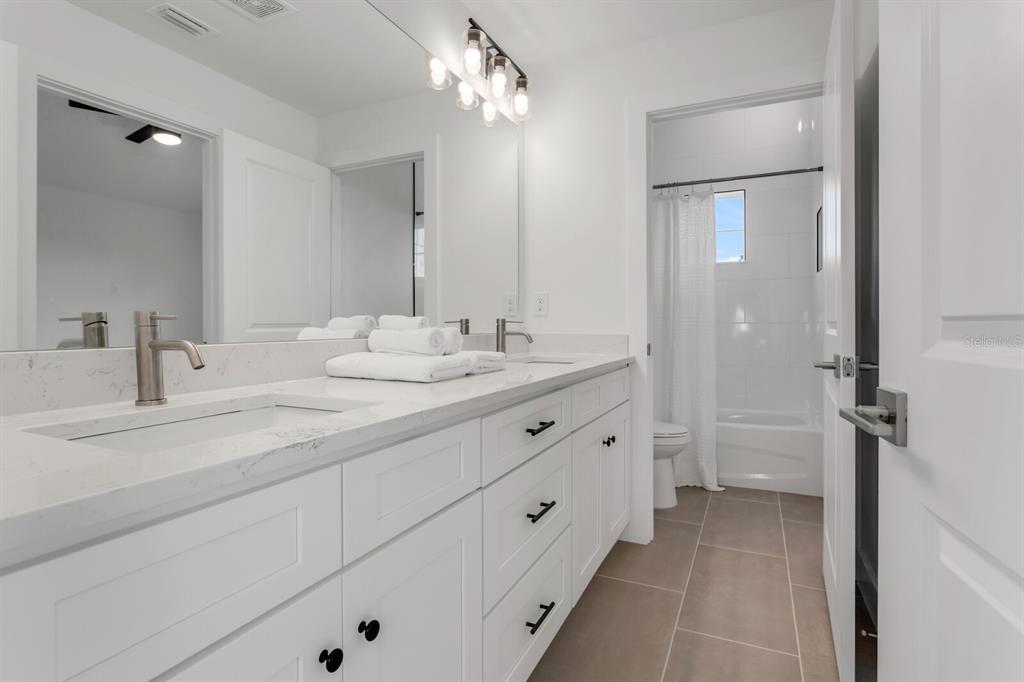 1912 West Chestnut Street Tampa, FL 33607 - Photo 29 of 30 a bathroom with a double vanity sink mirror and double