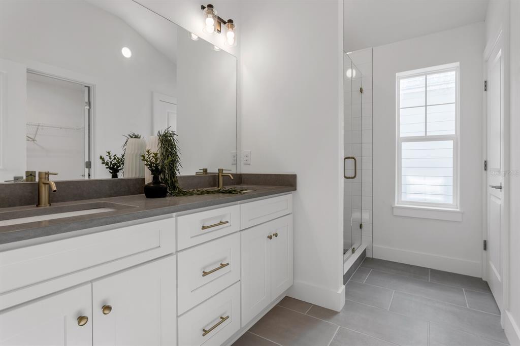 1912 West Chestnut Street Tampa, FL 33607 - Photo 30 of 30 a bathroom with a granite countertop sink a mirror and a window