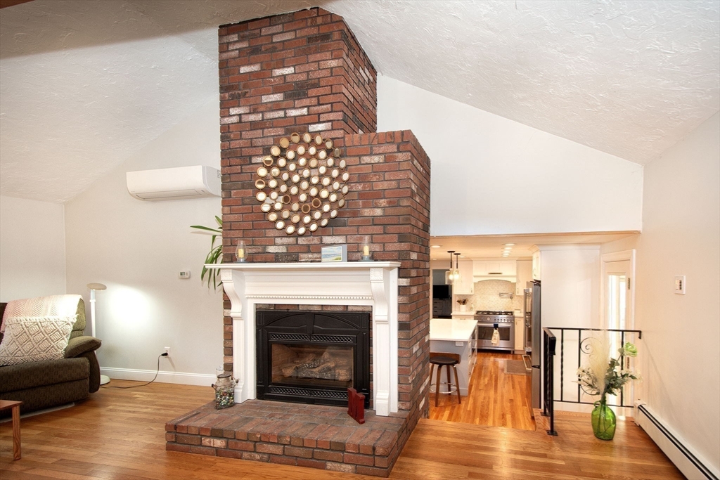 18 Longmeadow Road Scituate, MA 02066 - Photo 15 of 37 a living room with furniture and a fireplace