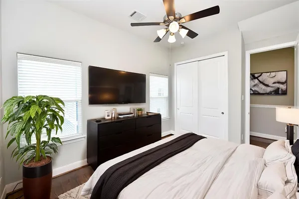 a bedroom with a bed and a flat screen tv