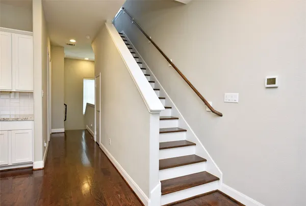 a view of entryway and hall with wooden floor