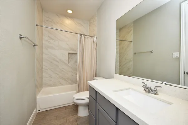 a bathroom with a sink toilet and shower