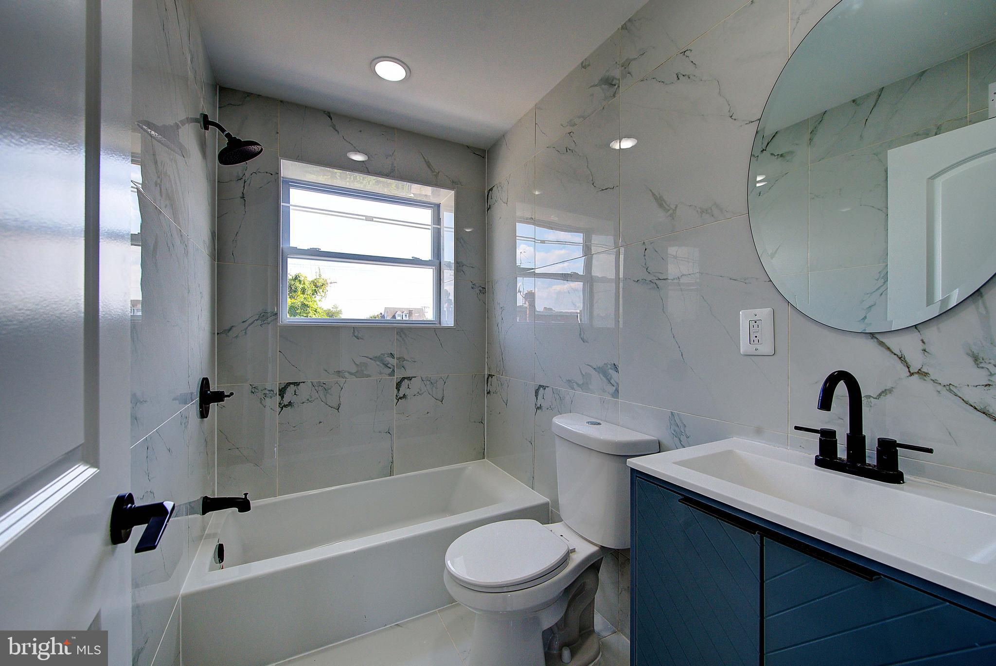 5736 Reedland Street Philadelphia, PA 19143 - Photo 13 of 22 a bathroom with a sink a toilet and shower