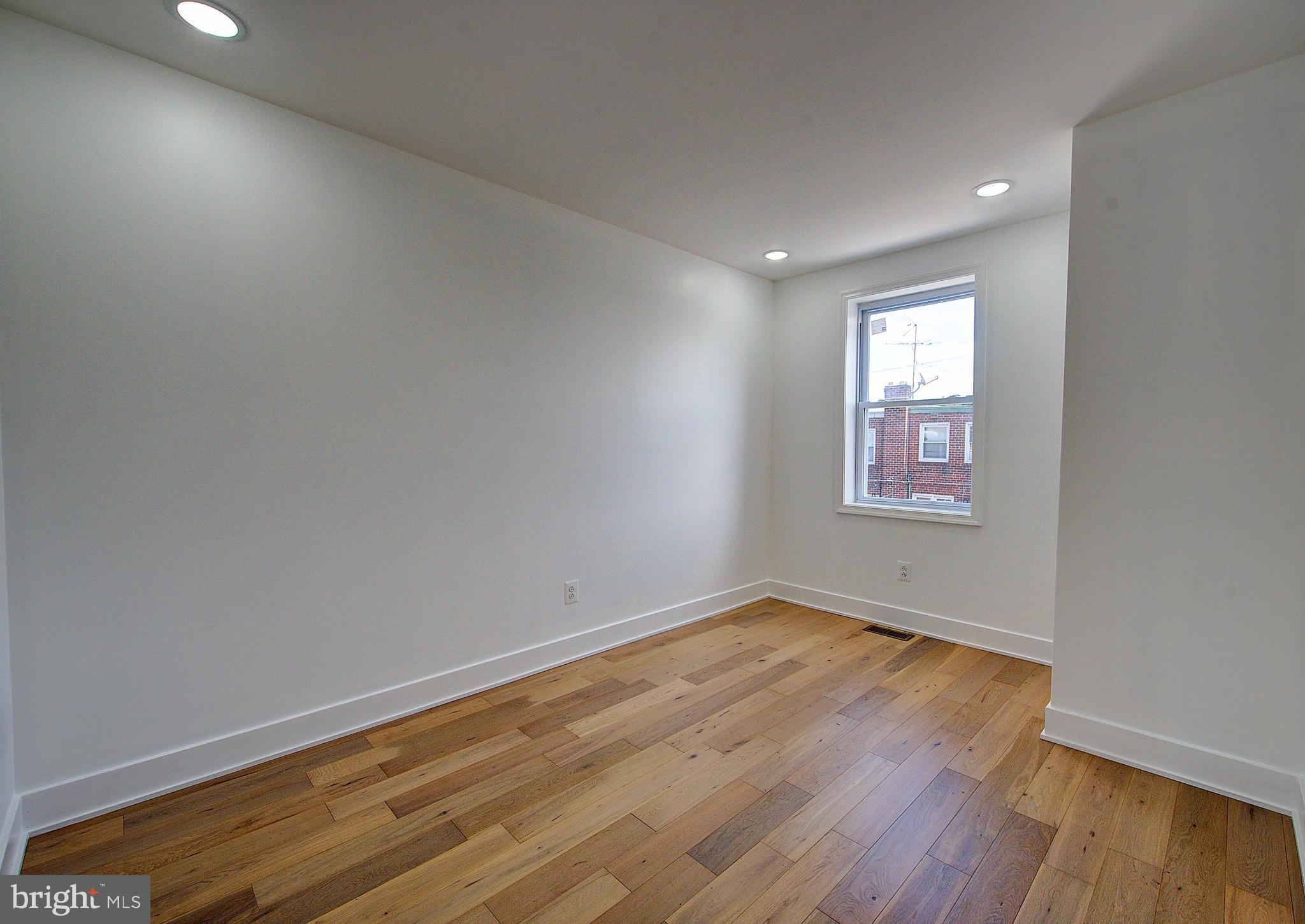 5736 Reedland Street Philadelphia, PA 19143 - Photo 14 of 22 an empty room with wooden floor and windows
