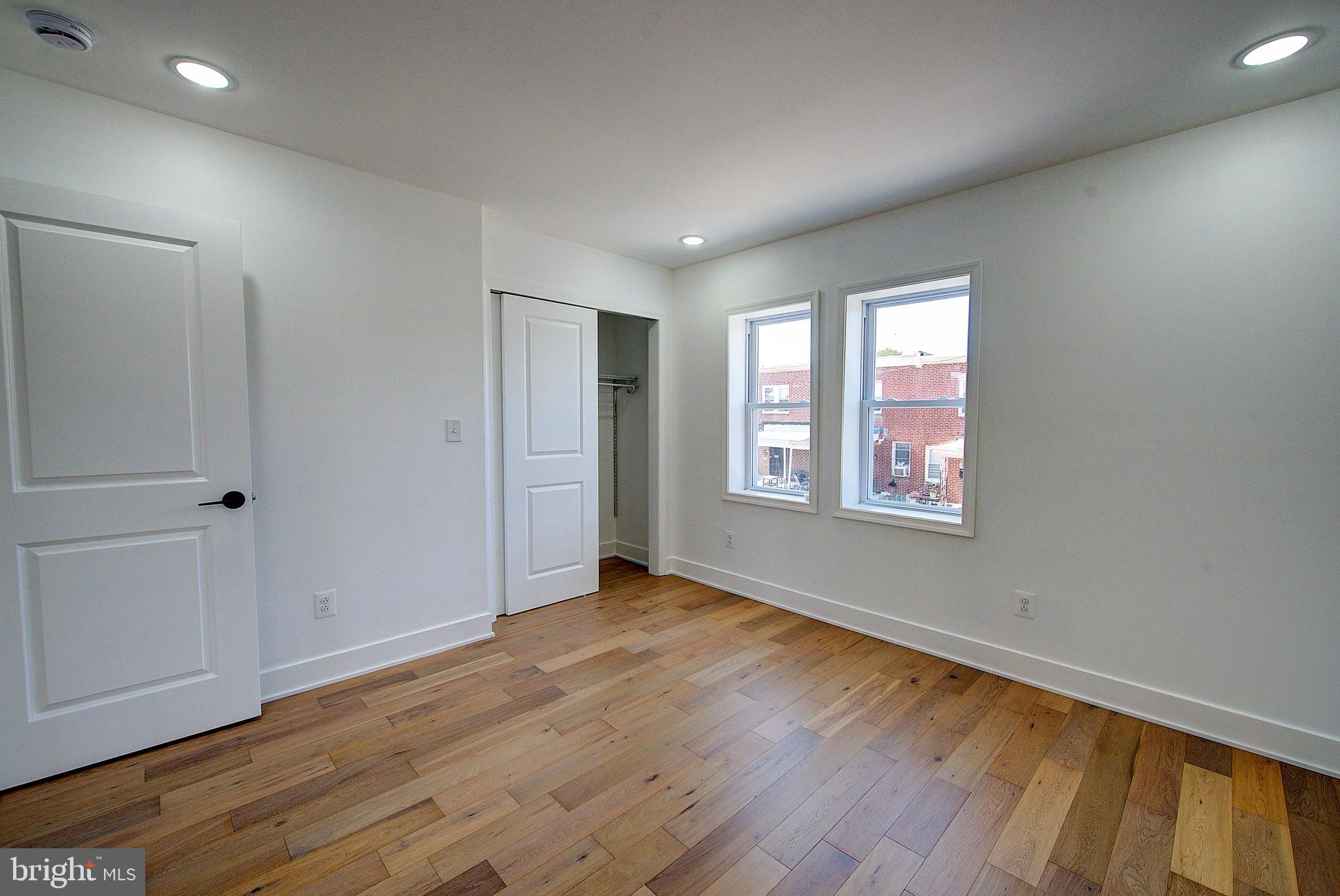 5736 Reedland Street Philadelphia, PA 19143 - Photo 15 of 22 an empty room with wooden floor and windows