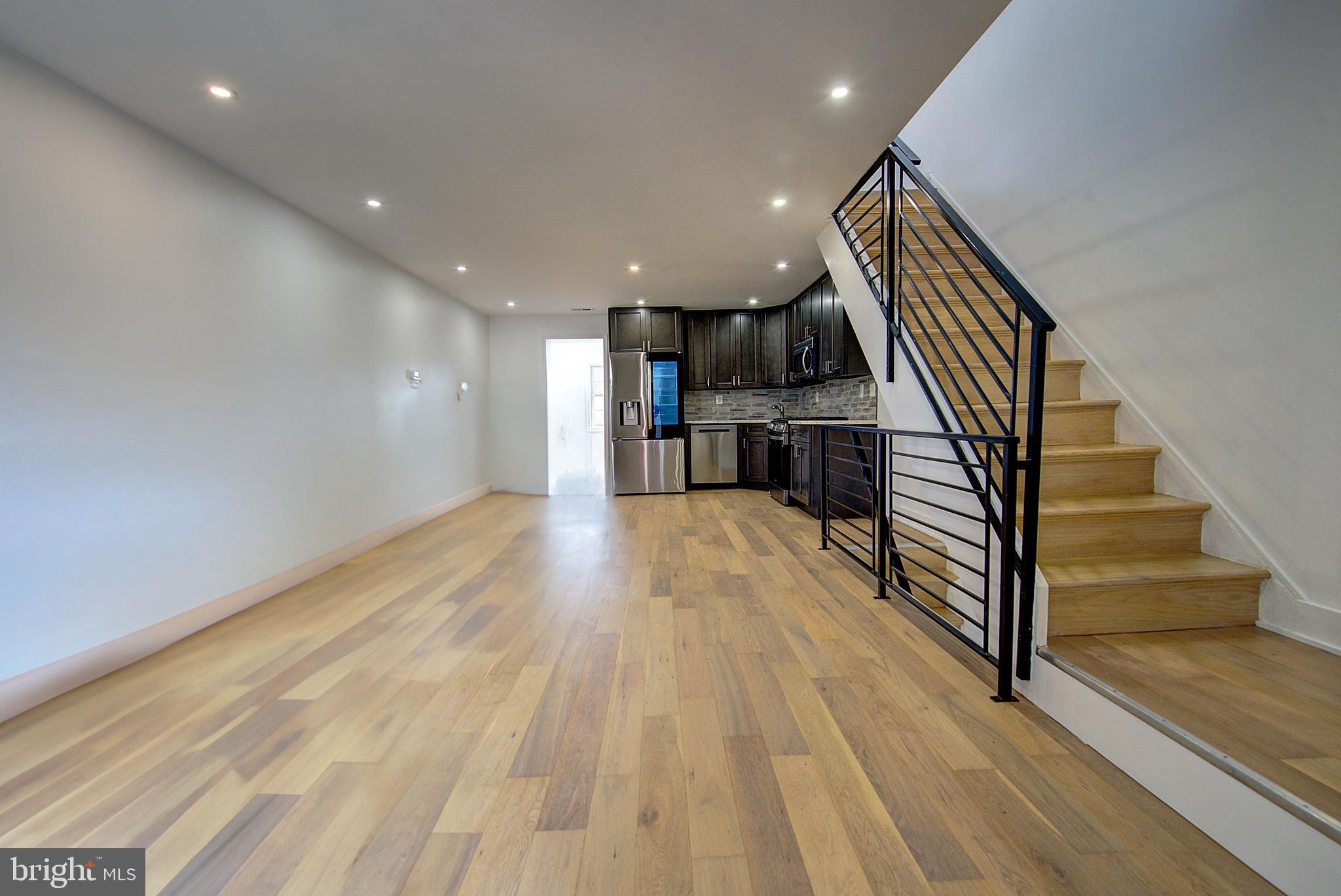 5736 Reedland Street Philadelphia, PA 19143 - Photo 4 of 22 a view of entryway with wooden floor and stairs