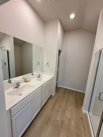 a bathroom with a double vanity sink and mirror