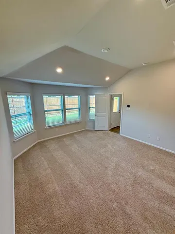 a view of an empty room with windows