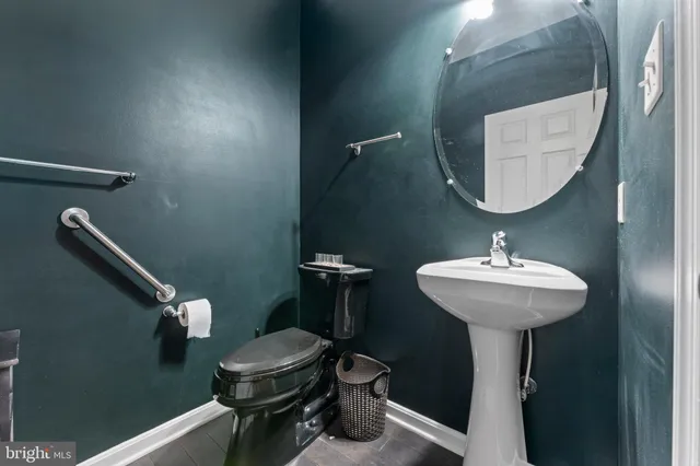 a bathroom with a sink a toilet and a mirror