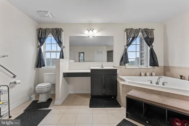 a spacious bathroom with a sink and a mirror