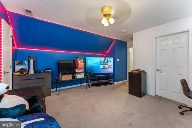 a bedroom with furniture and a flat screen tv