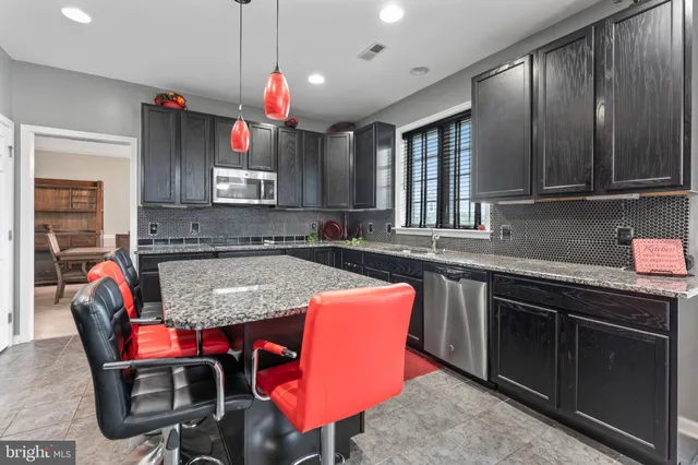 a kitchen with granite countertop a sink cabinets and window