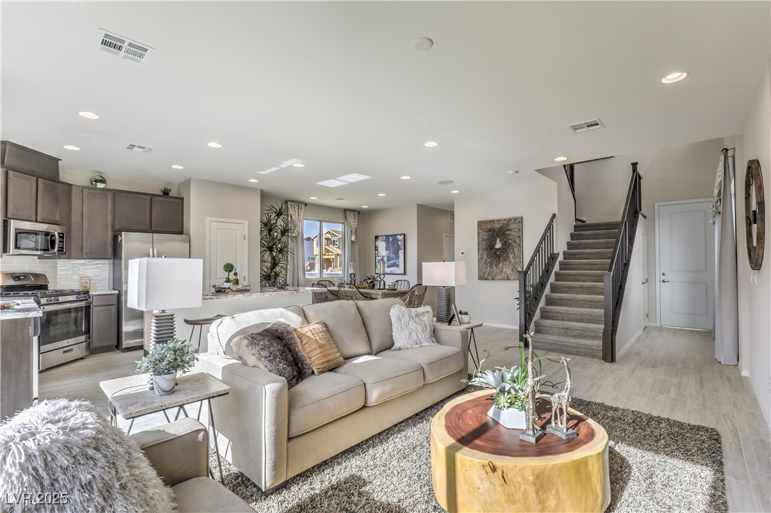 8929 Pebble Sand Street Las Vegas, NV 89178 - Photo 1 of 2 Living area featuring recessed lighting, stairs, light wood-style floors, and visible vents