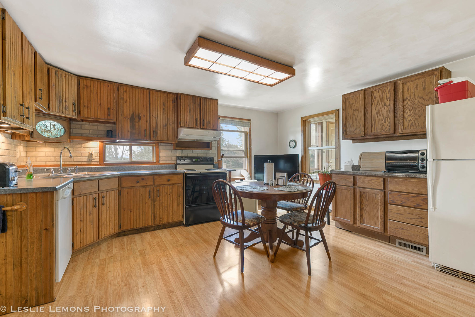16276 Willrett Road Malta, IL 60150 - Photo 9 of 25 a kitchen with a table chairs refrigerator and microwave