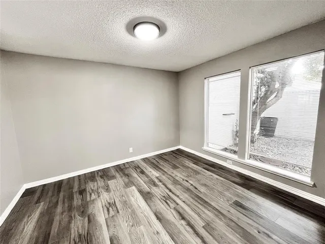 a view of a room with wooden floor and doors