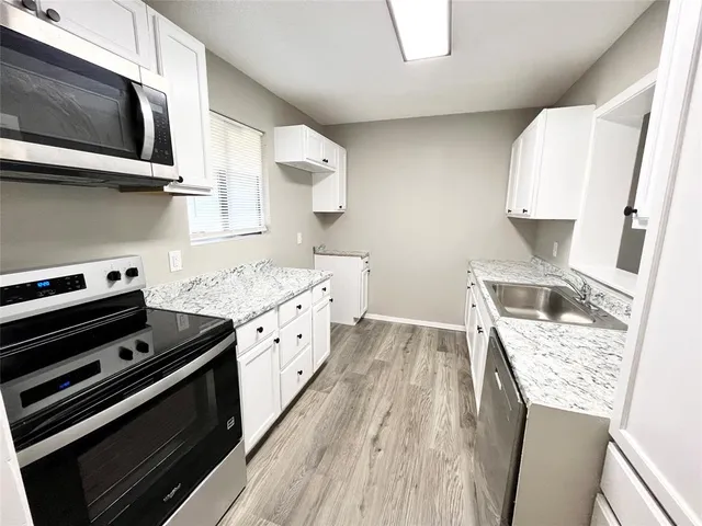 a kitchen with a stove and a microwave