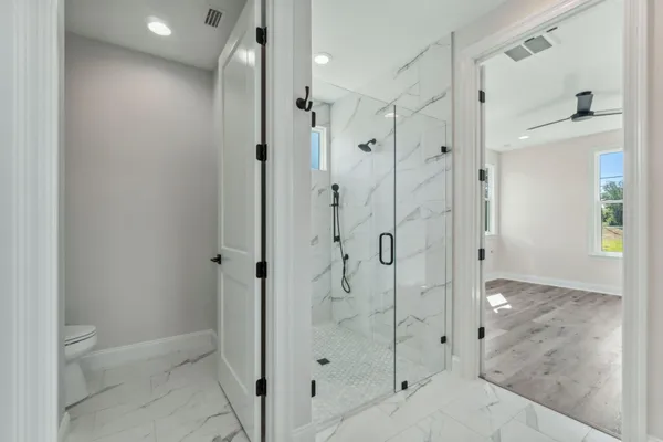 a bathroom with a shower and a glass door