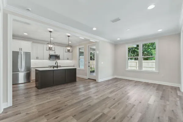 a large room with a large window and stainless steel appliances