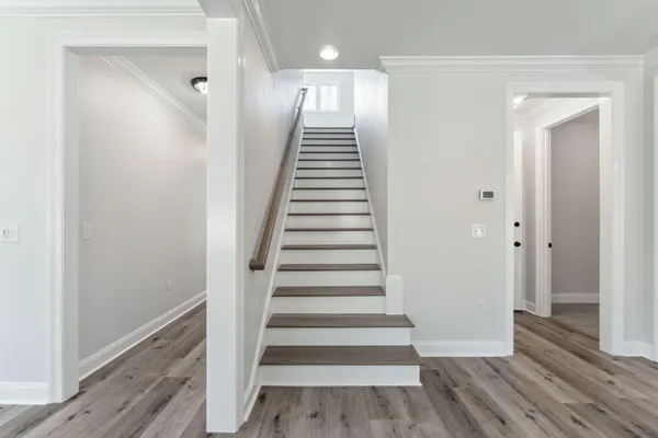 a view of an entryway with wooden floor