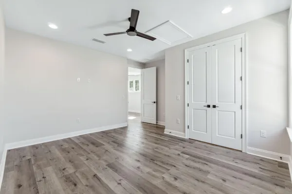 a view of an empty room with wooden floor